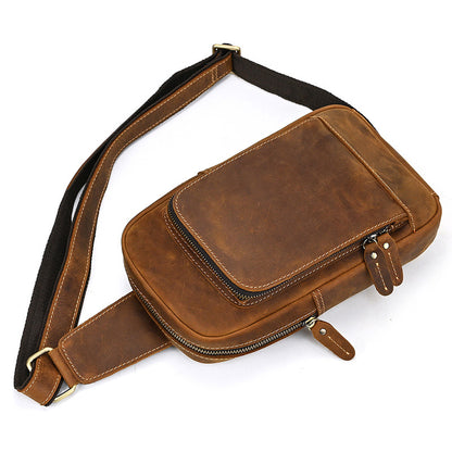 Brown leather waist bag with a strap on a white background