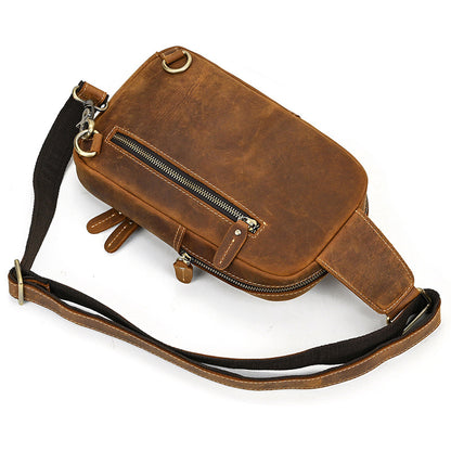 Brown leather waist bag with a strap on a white background