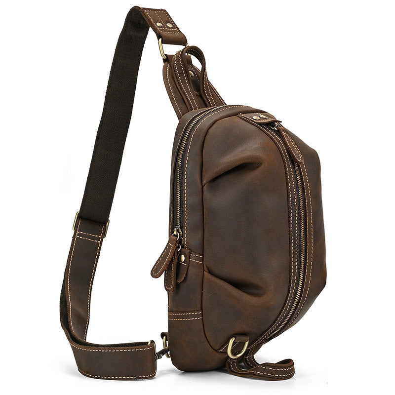 Timber Carry dark brown Crazy Horse Leather Sling Pack, left side view detailing the strap attachment and rugged leather finish.
