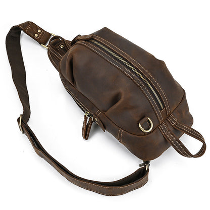 Top down angle view of the Crazy Horse Leather Travel Sling Bag by Timber Carry, focusing on the main compartment zipper opening.