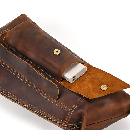 Brown leather bag with a power bank attached on a white background