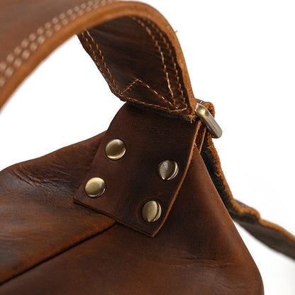 Detailed view of the durable shoulder strap and metal hardware on the Timber Carry Vertical Crossbody Pack.