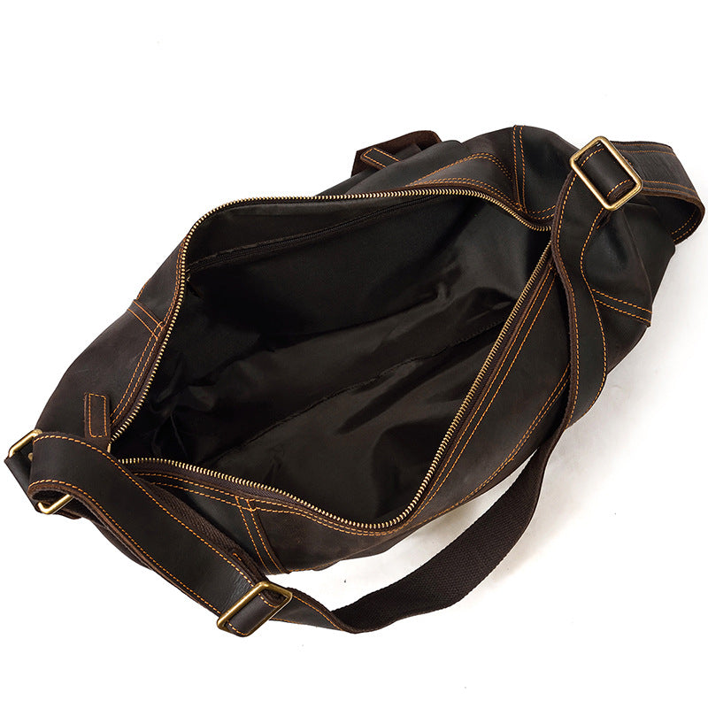 Wide-open main compartment of the Large Capacity dark brown Vertical Crossbody Pack, showing the spacious interior lining.