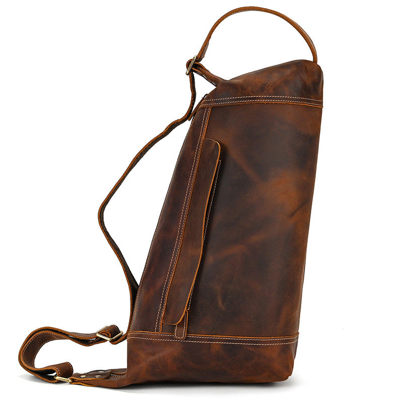 Side profile of Timber Carry Vertical Crossbody Pack, showcasing the deep storage capacity and rugged leather finish.