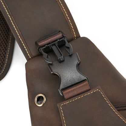 Close-up of a brown leather bag with a black buckle on a white background