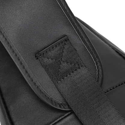 Close-up of a black leather bag with a strap and visible stitching detail.