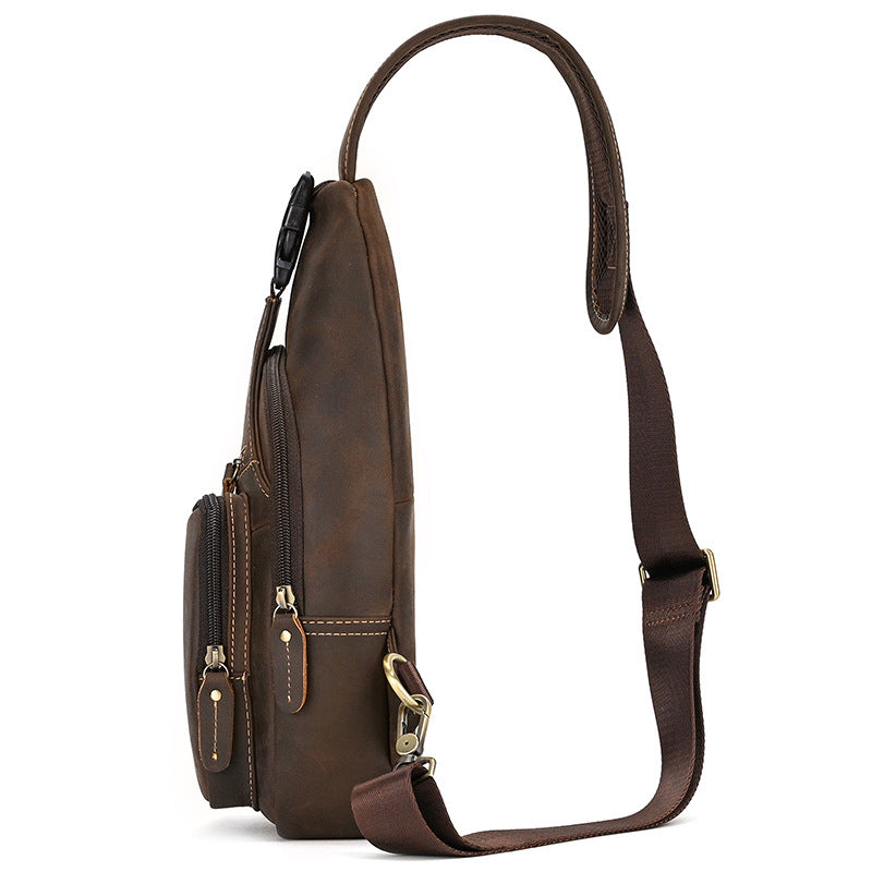 Side view of Brown leather sling bag with multiple pockets on a white background