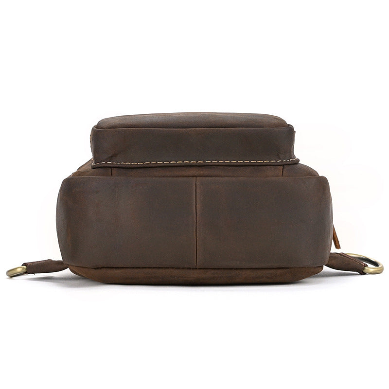 bottom view of Brown leather backpack on a white background