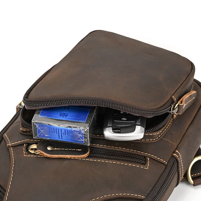 Brown leather pouch with a car key and license plate holder inside on a white background
