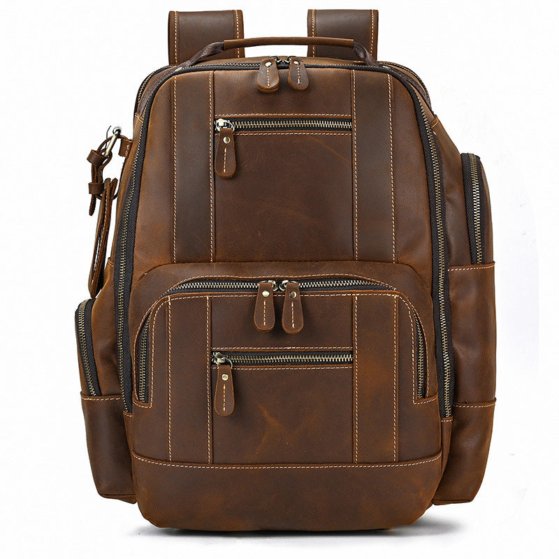 Brown leather backpack with multiple pockets and zippers on a white background