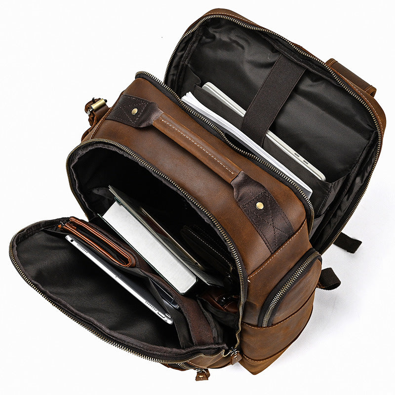 Brown leather backpack with compartments on a white background