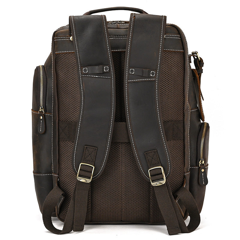 Dark Brown leather backpack with multiple pockets and straps on a white background