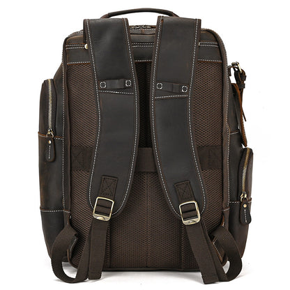 Dark Brown leather backpack with multiple pockets and straps on a white background