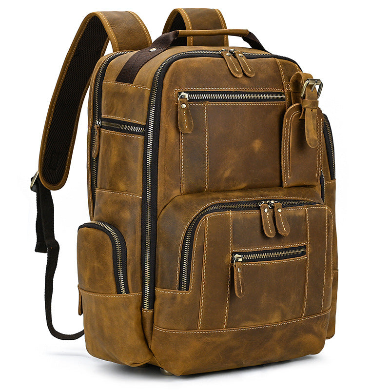 Light Brown leather backpack with multiple pockets and zippers on a white background