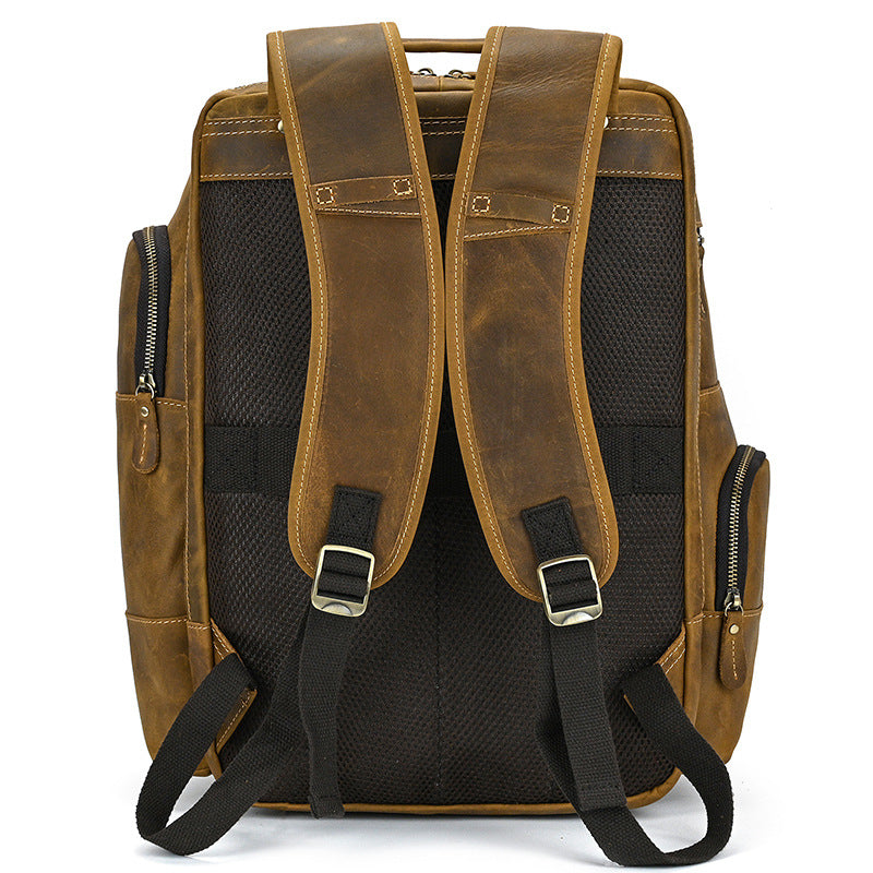 Light Brown leather backpack with black straps on a white background