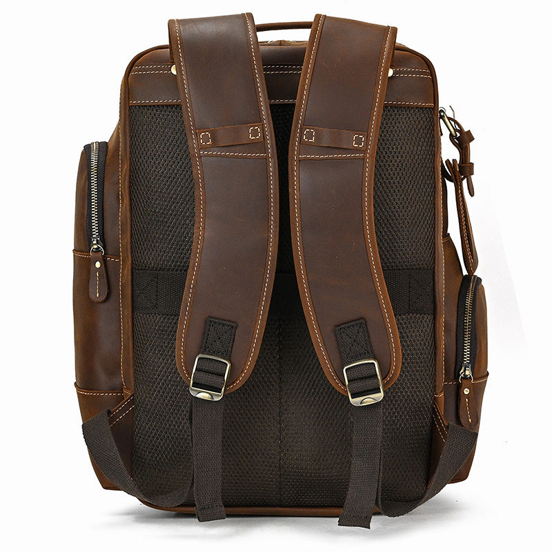 Brown leather backpack with black mesh sides on a white background