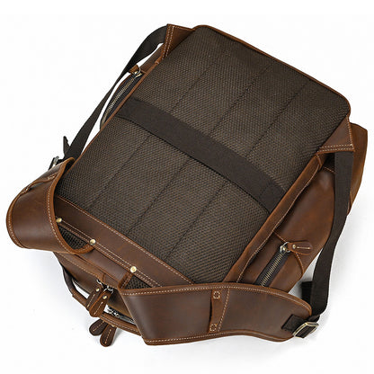 Brown leather backpack with black interior on a white background