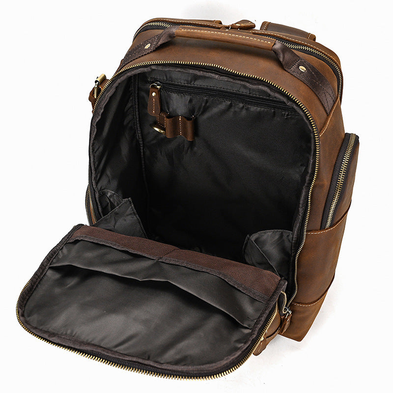 Brown leather backpack with open front compartment on a white background