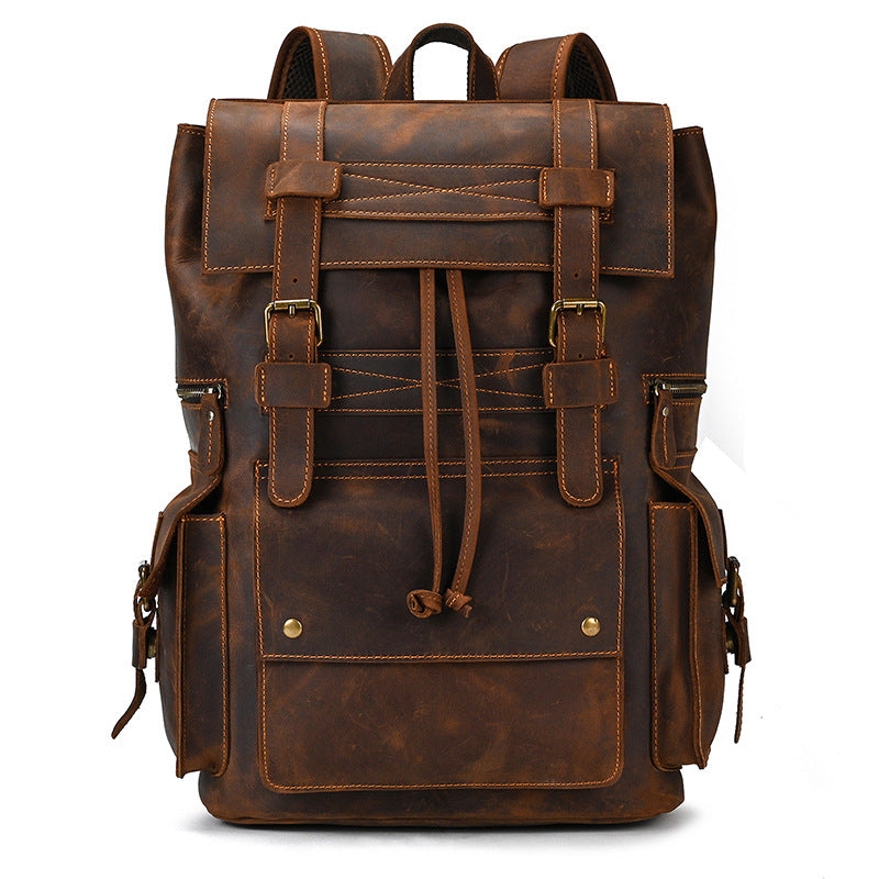 Brown leather backpack with multiple straps and buckles on a white background