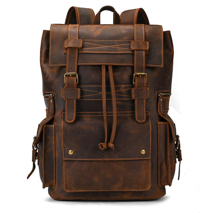 Brown leather backpack with multiple straps and buckles on a white background