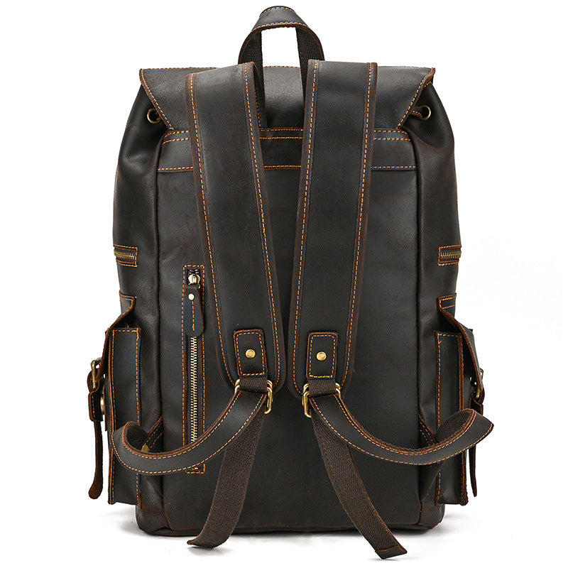 Black leather backpack with brown accents on a white background