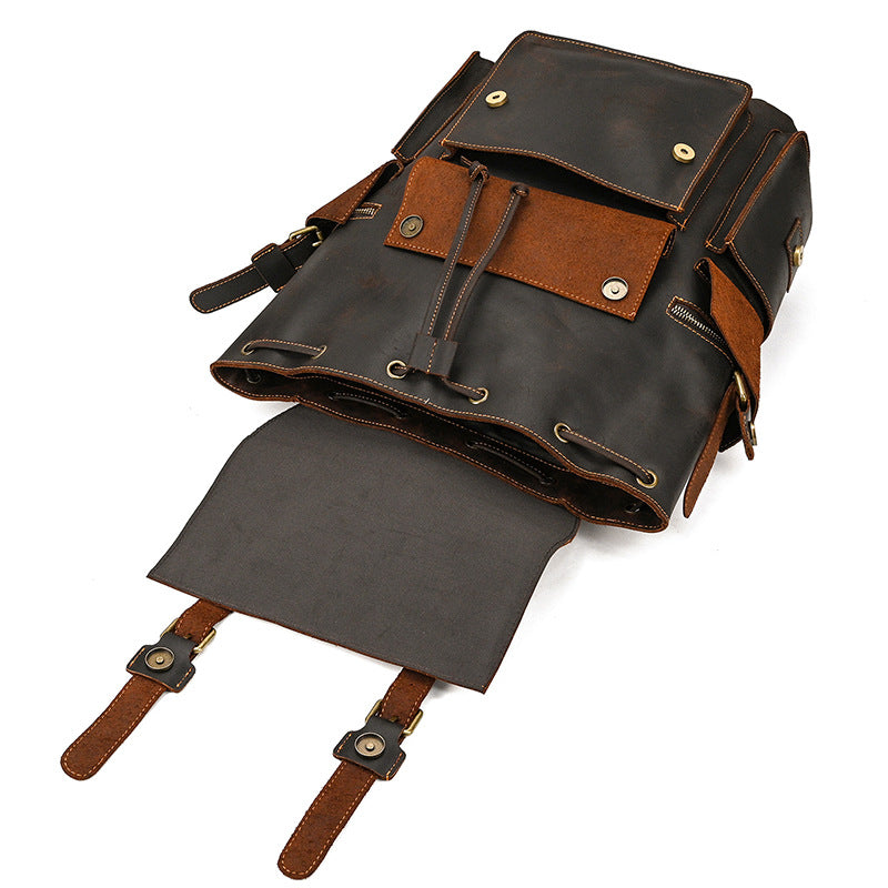 Brown leather backpack with gray interior on a white background
