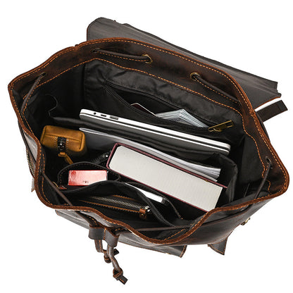 Open leather briefcase with various items inside on a white background