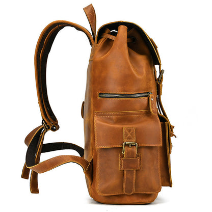 Vintage brown leather travel backpack with front buckle pocket and zipper detail, side view