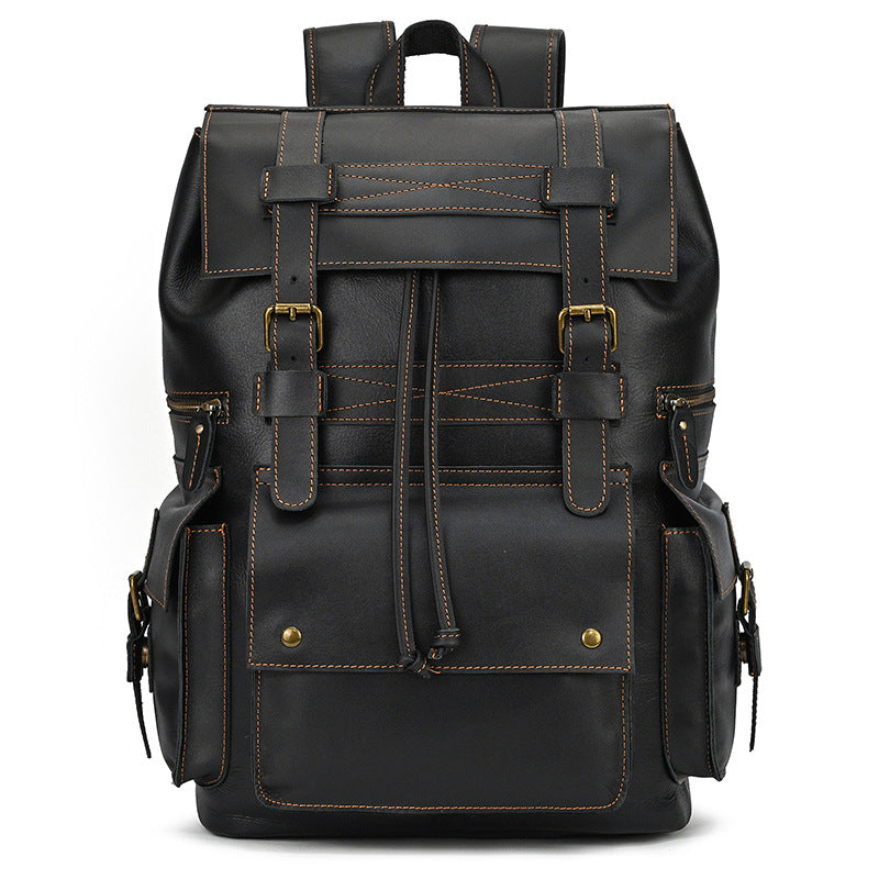 Black leather backpack with gold buckles on a white background