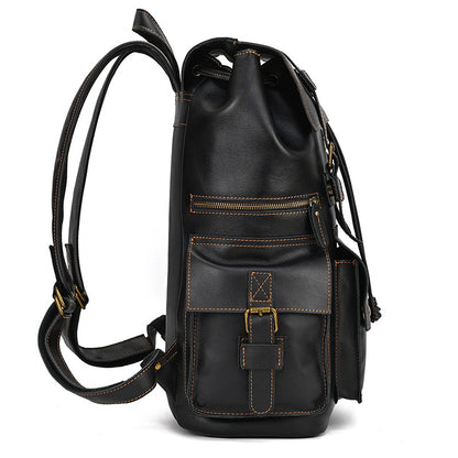 Black leather backpack with gold buckles on a white background