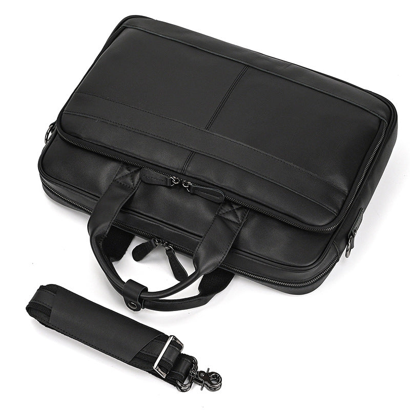 Black briefcase with a shoulder strap on a white background