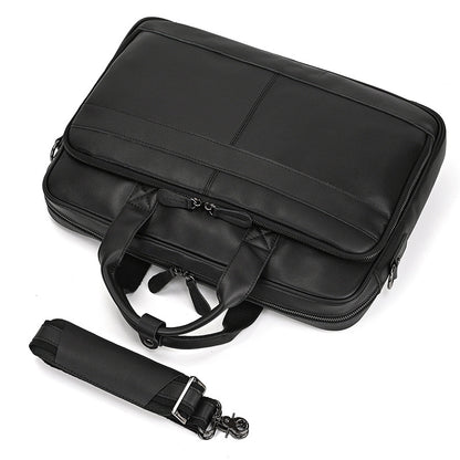 Black briefcase with a shoulder strap on a white background