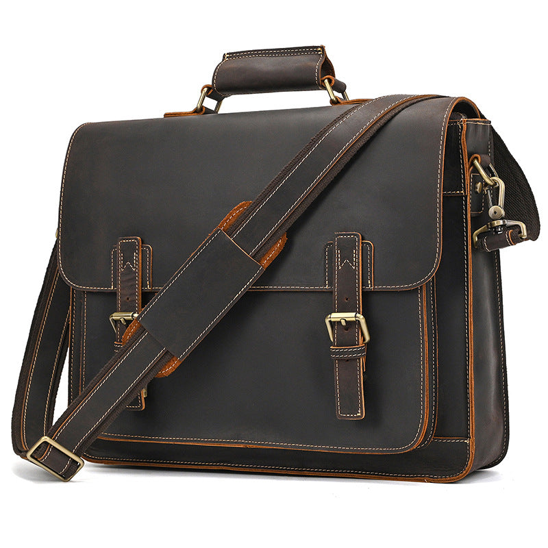 Front perspective of classic dark brown leather briefcase with detachable shoulder strap and comfortable handle for business commute.
