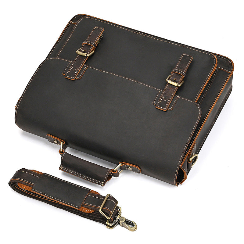 Top-down view of dark brown leather briefcase with dual buckle straps and a matching detachable shoulder strap.