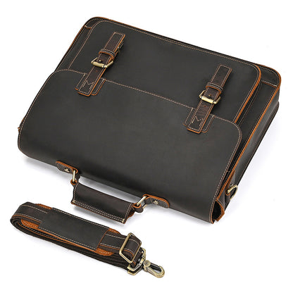 Top-down view of dark brown leather briefcase with dual buckle straps and a matching detachable shoulder strap.