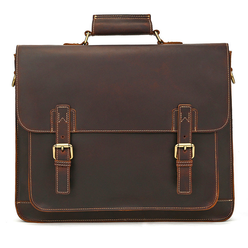Clean front perspective of slim minimal dark brown leather corporate briefcase on white background.