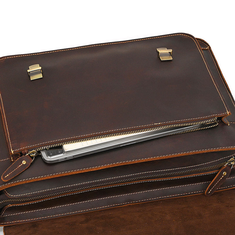 Brown leather briefcase with gold hardware on a white background