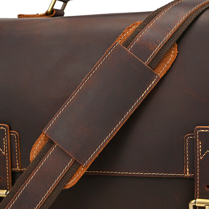 Close-up of a brown leather bag with a strap