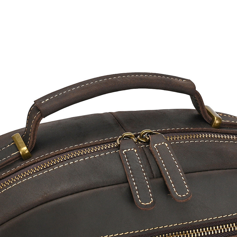 Close-up of a Dark Brown leather bag with gold zippers on a white background