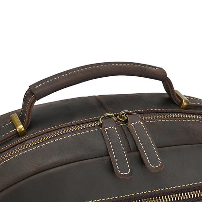 Close-up of a Dark Brown leather bag with gold zippers on a white background