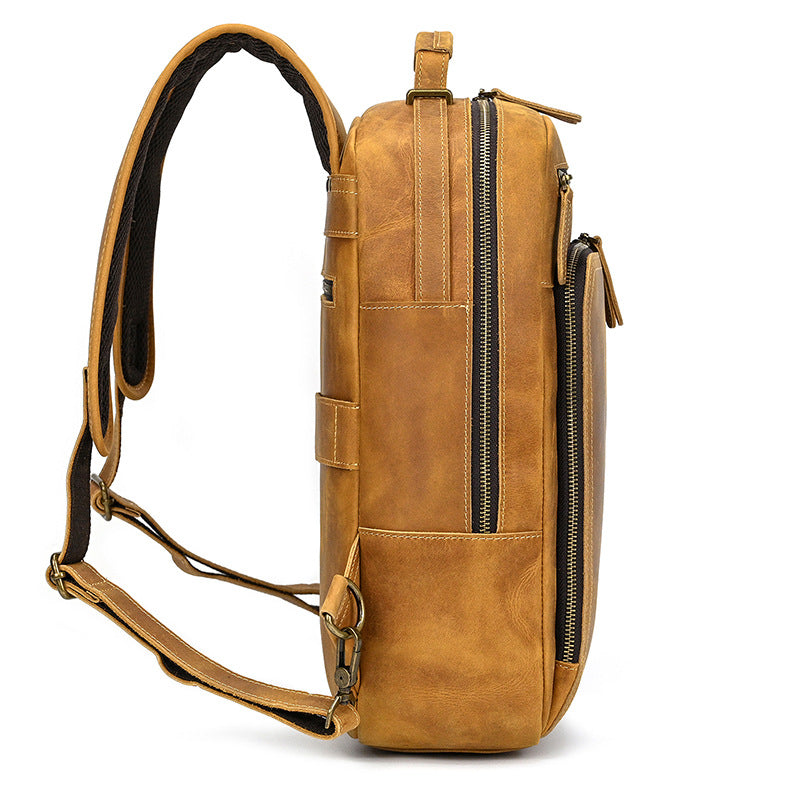 Brown leather backpack with multiple zippers on a white background