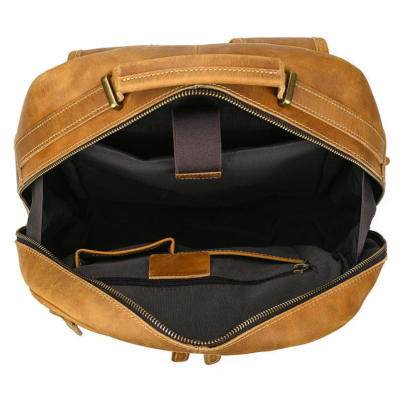 Brown leather backpack with open front compartment on a white background