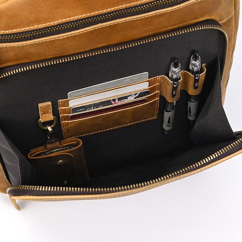 Brown leather bag with compartments for pens and cards on a white background