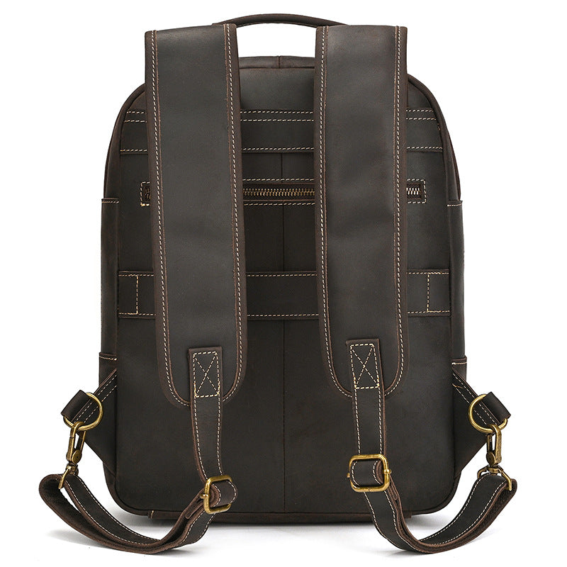 Back view of a Dark Brown leather backpack with gold buckles on a white background