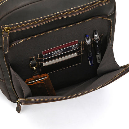 Open Dark Brown leather bag with compartments holding items on a white background