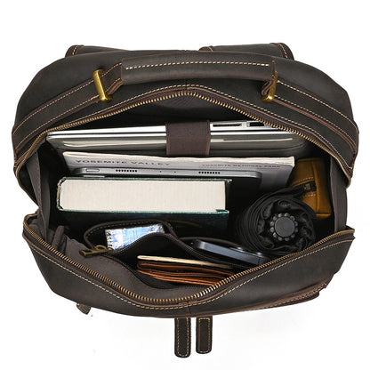 Dark Brown leather backpack with items inside on a white background