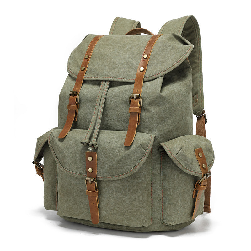 A 45-degree angle view of the Timbercarry vintage canvas multi-pocket backpack in army green, featuring brown leather straps and brass hardware details.