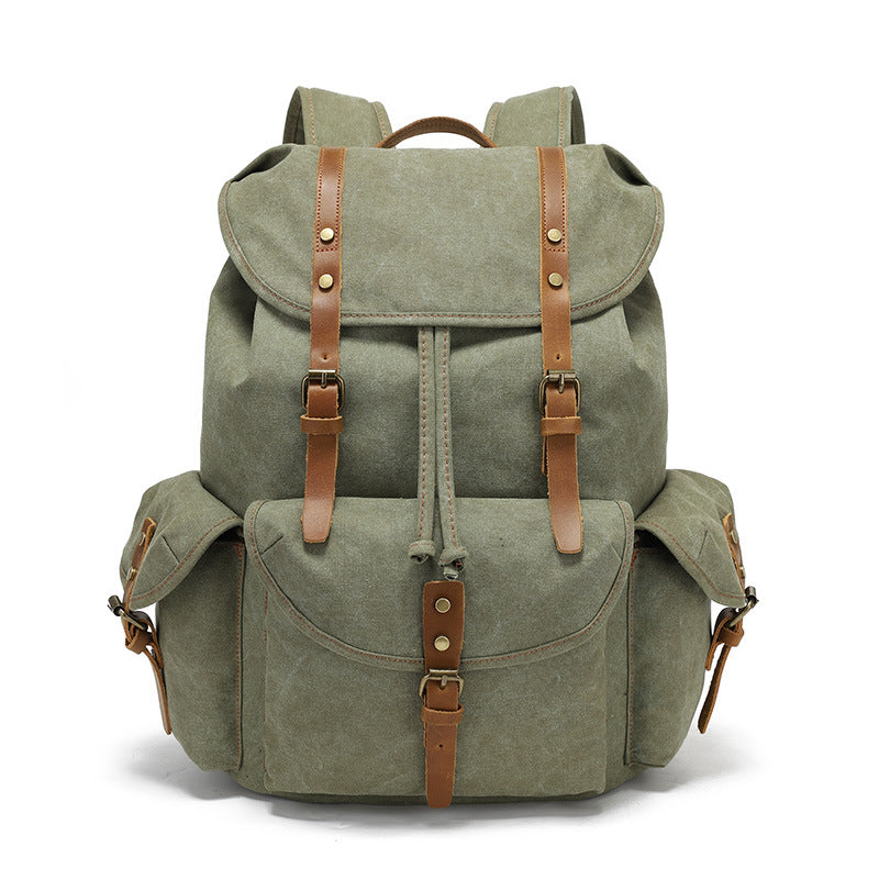 Front view of the Timbercarry vintage canvas multi-pocket backpack in army green, showcasing the flap cover, drawstring closure, and three external buckled pockets.