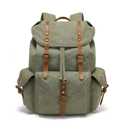 Front view of the Timbercarry vintage canvas multi-pocket backpack in army green, showcasing the flap cover, drawstring closure, and three external buckled pockets.