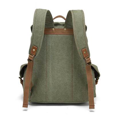 Back view of the Timbercarry vintage canvas multi-pocket backpack in army green, highlighting the adjustable padded shoulder straps and sturdy top handle.